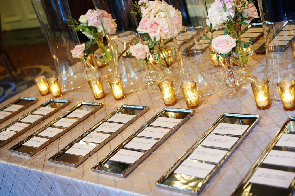 wedding escort cards displayed on silver trays