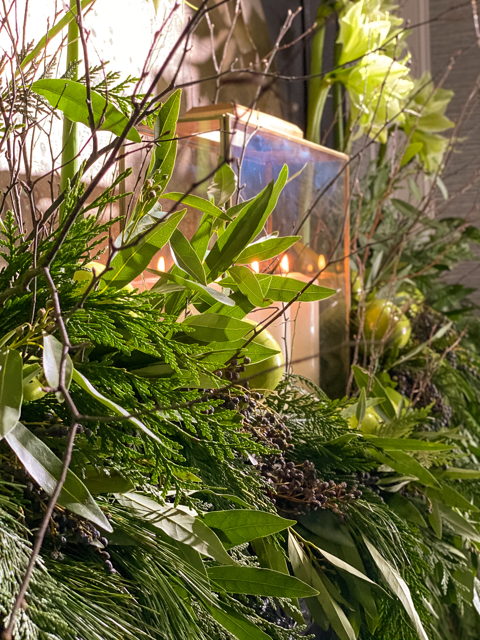 Green flowers and green apples on mantle with garlands to match