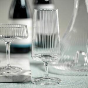 fluted textured cocktail glass with stem displayed with other glasses of the same collection