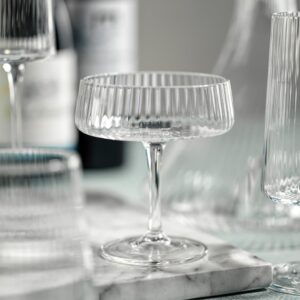 fluted textured martini or coupe glass displayed with other drinking glasses from the same collection