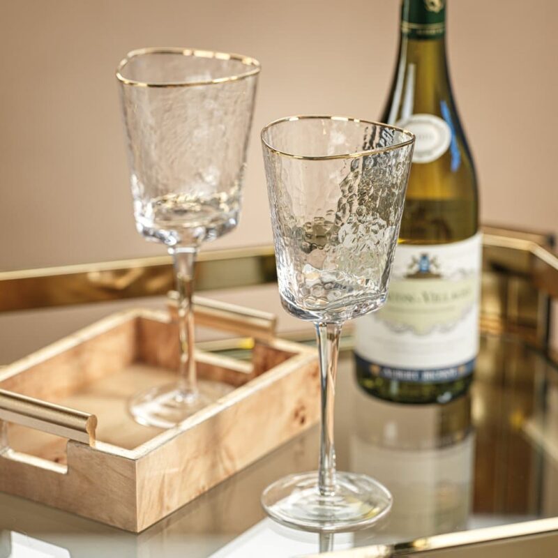 textured triangular stemmed wine glass with gold rim