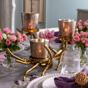 Gold Branch candelabra with silver and gold painted candle cups in a set of three resting on gold metal branch