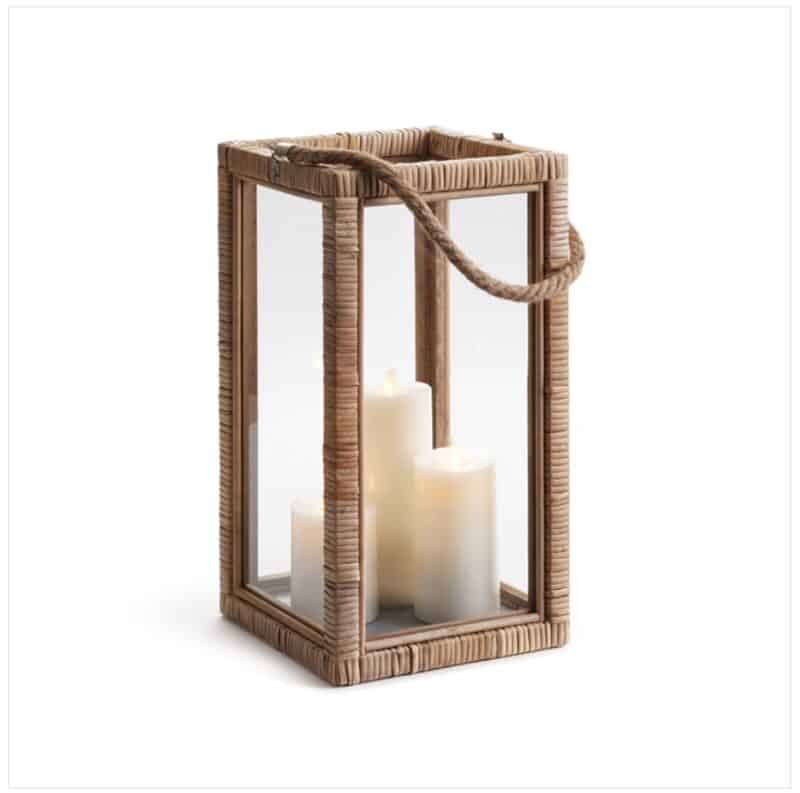 Rattan Lantern has clear glass panels on four sides, with an open square top and a rope handle. It can easily fit 3 3x3 pillar candles within.