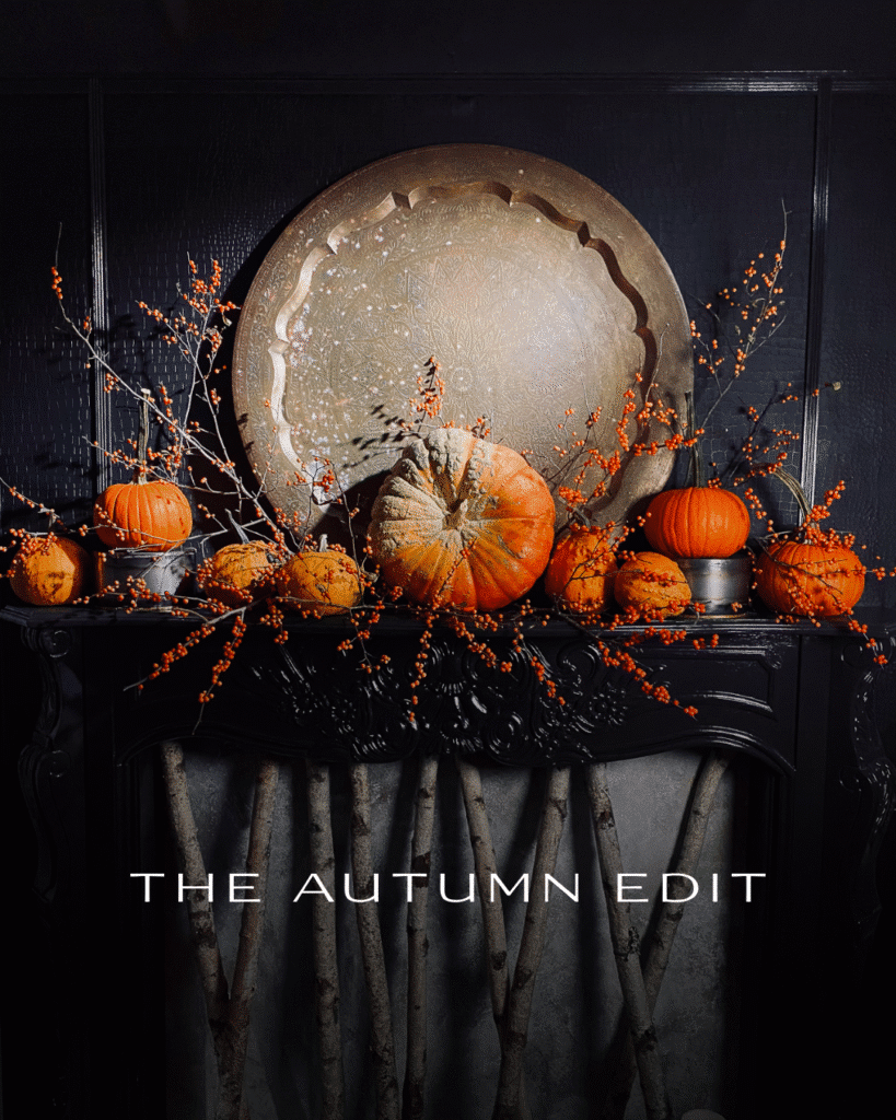 Pumpkins and berries on an black mantle for autumn
