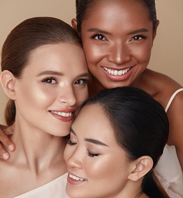 Diversity. Beauty Portrait Of Women. Multi-Ethnic Models With Natural Makeup And Perfect Skin Against Beige Background. Asian, Mixed Race And Caucasian Girls Standing Together And Looking At Camera.